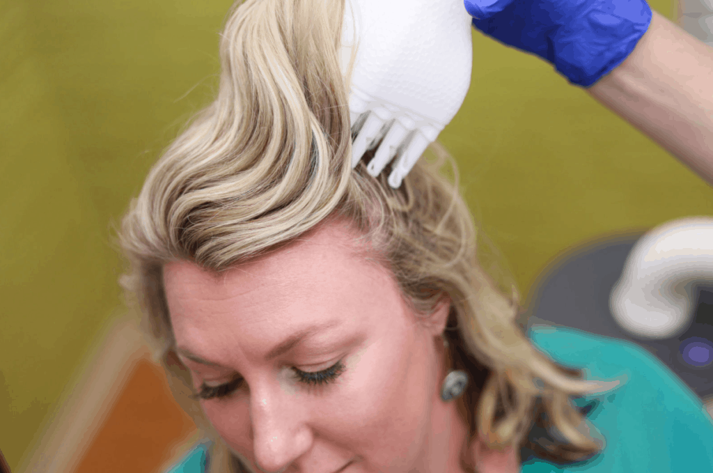 head lice professional using flosonix head lice device on woman patient